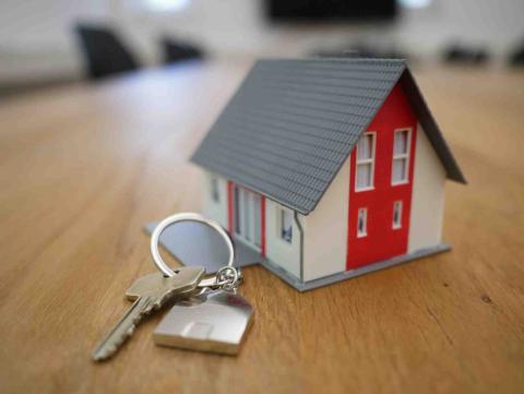 Set of keys beside miniature house